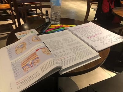 Academic textbook open on a coffee shop table