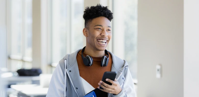 image of a student on campus holding their phone